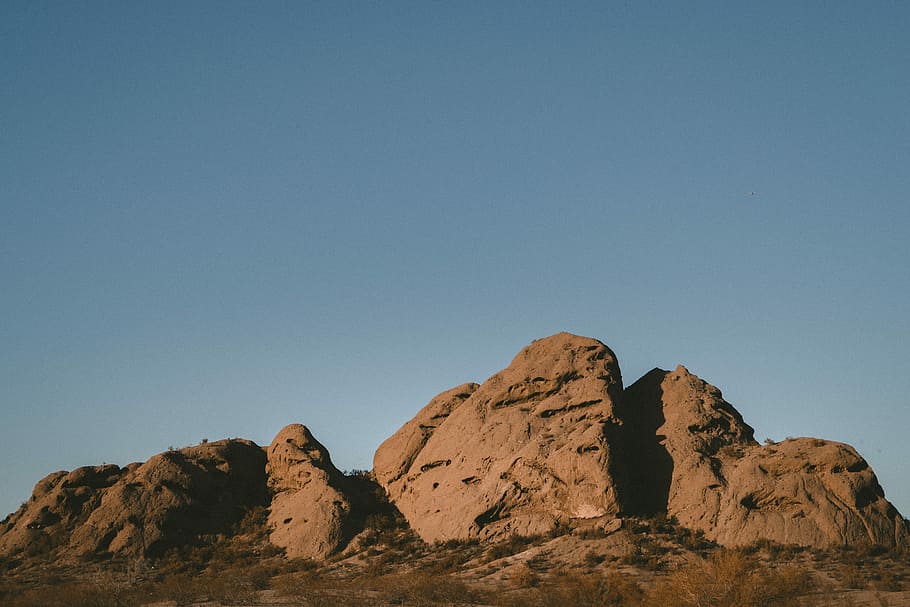 landscape photography of rock formation, rock formation under blue sky HD wallpaper