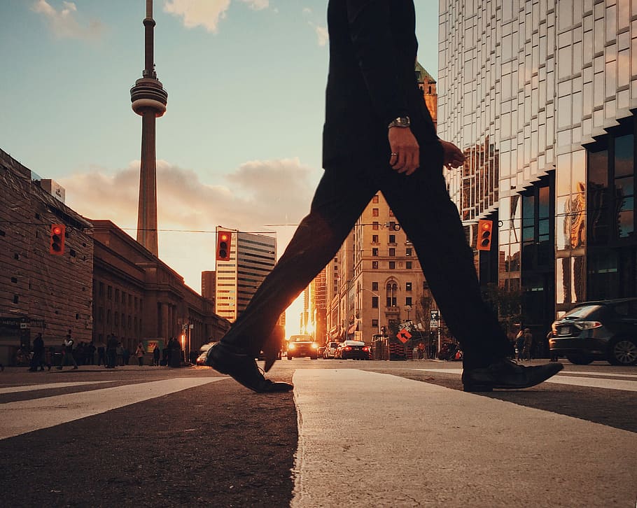 man in dress suit outfit walking in front of building, person walking on concrete road HD wallpaper
