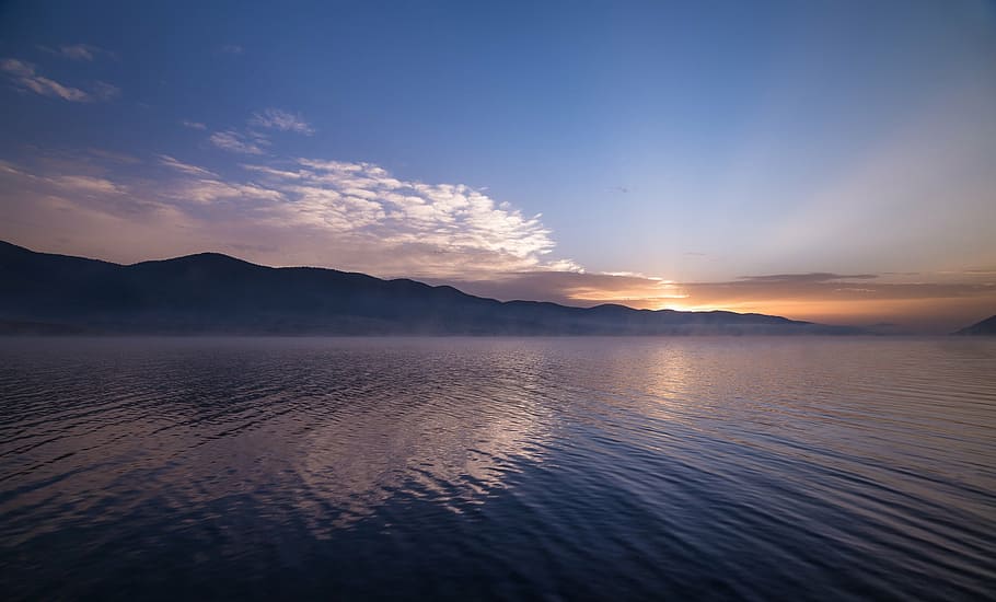 photography of calm body of water at golden hour, near, mountain HD wallpaper