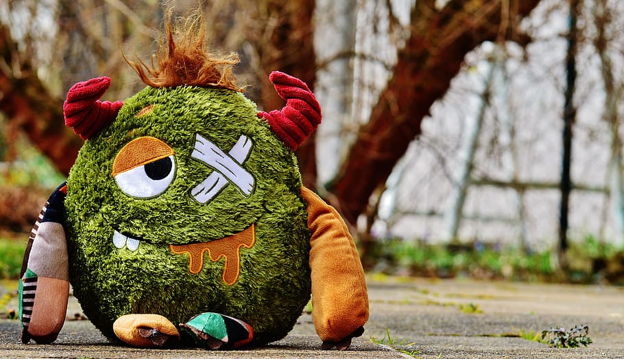 green, orange, and red monster plush toy on gray pavement, stuffed animal, HD wallpaper