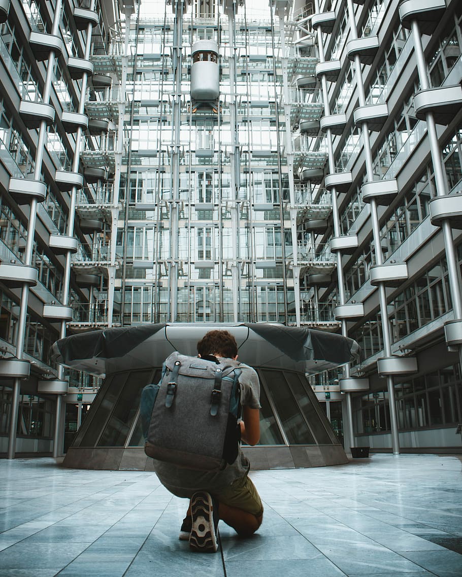 Is that our future, man kneeling on floor, architecture, modern architecture HD wallpaper