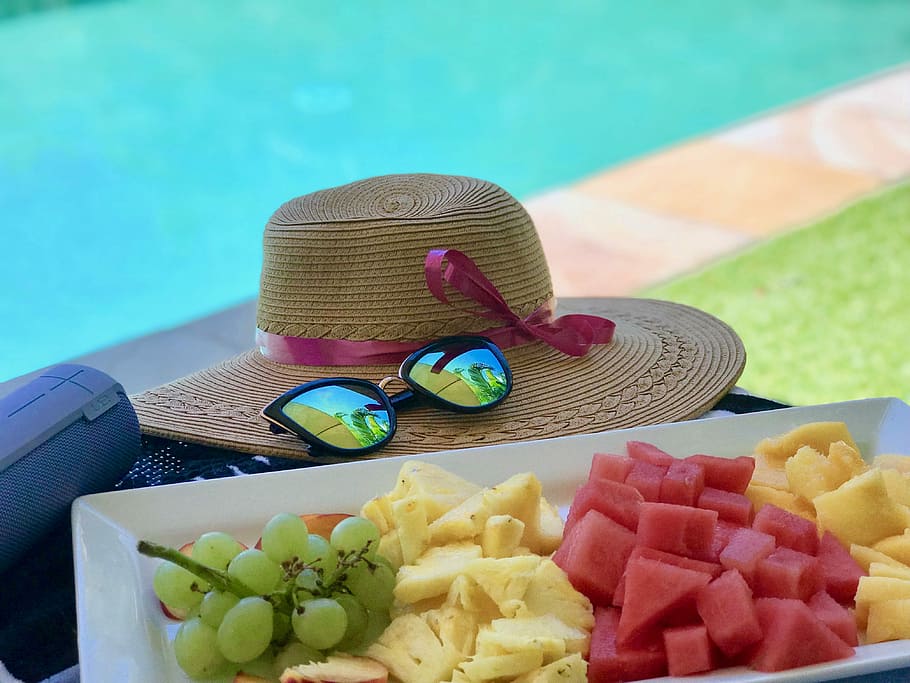 sliced fruits on white tray next to sunglasses and straw hat, slice fruits on white tray beside hat HD wallpaper