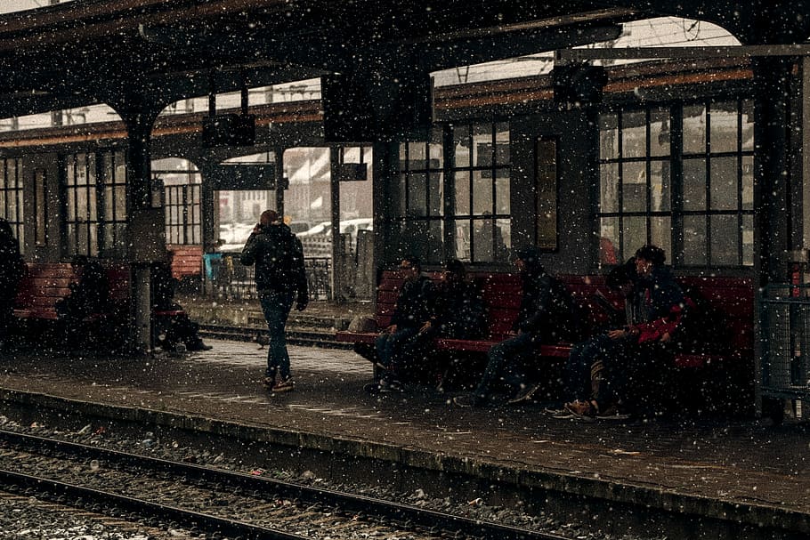 people sitting near station during winter, person walking near train rail HD wallpaper