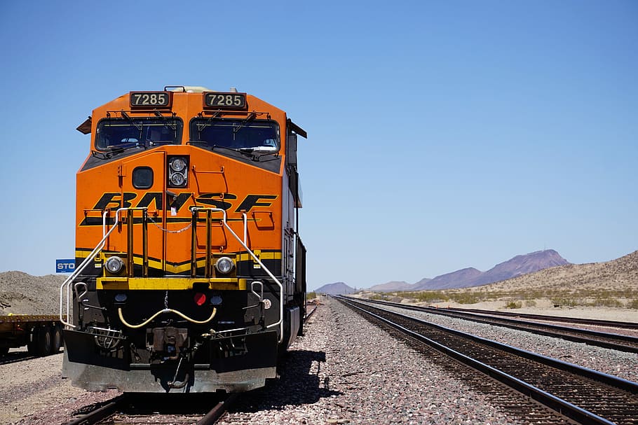 orange BNSF train at the rail, red train traveling, railroad