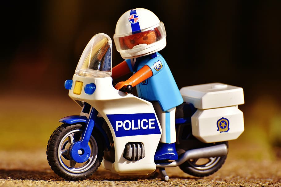 Lego police riding on touring motorcycle miniature, cop, two wheeled vehicle