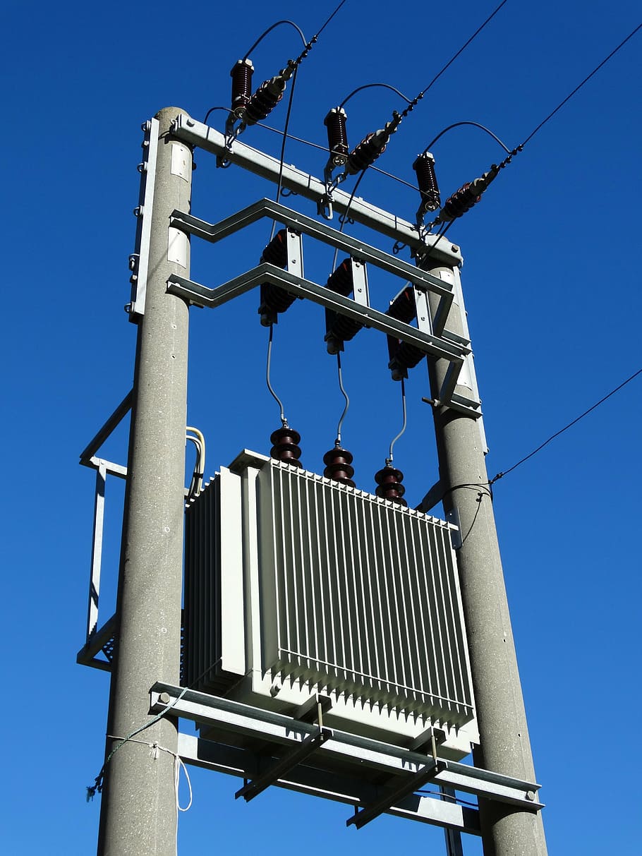gray electric post under blue sky, transformer, power station