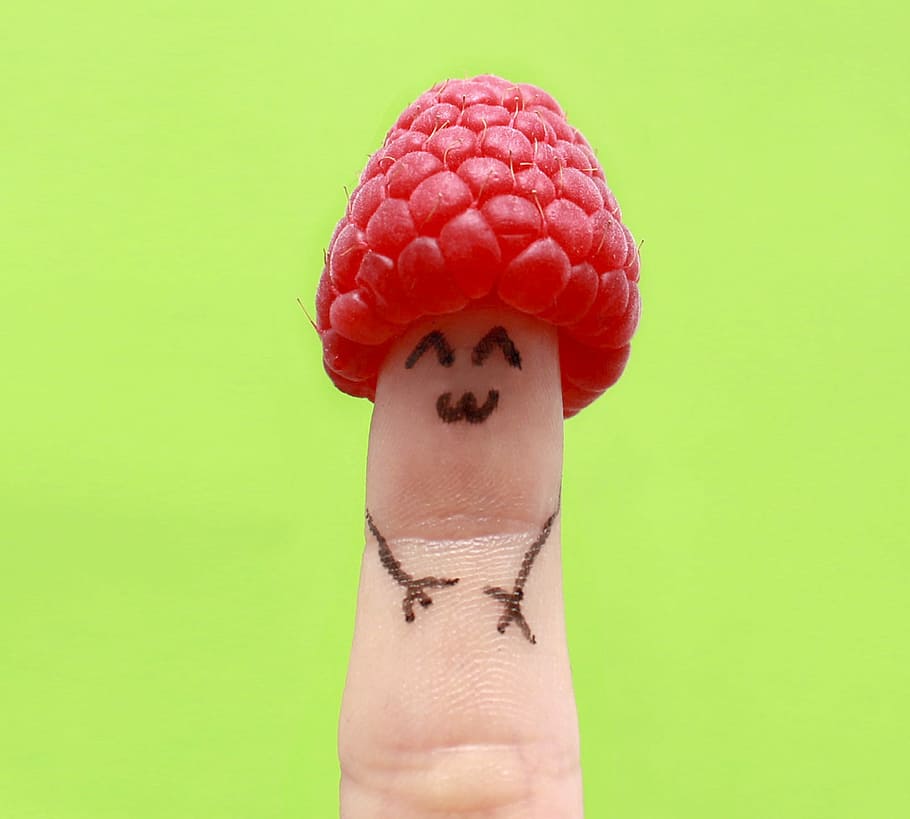 red raspberry on person's finger, fun, happy, face, hand, detail HD wallpaper