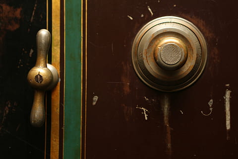 two brass-colored personal safe knobs, gold, door, vault, combination HD wallpaper