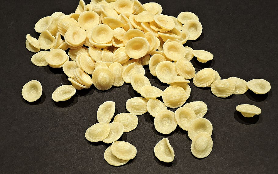 chips on black surface, orecchiette pasta, apulia italy, ear shaped