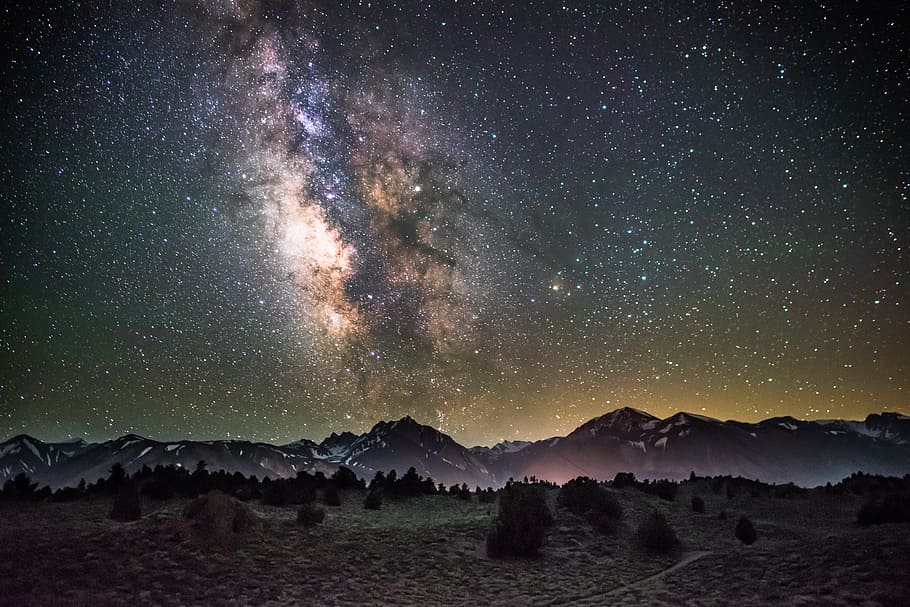 silhouette of mountains under milky way galaxy, painting of black and green mountain during night time