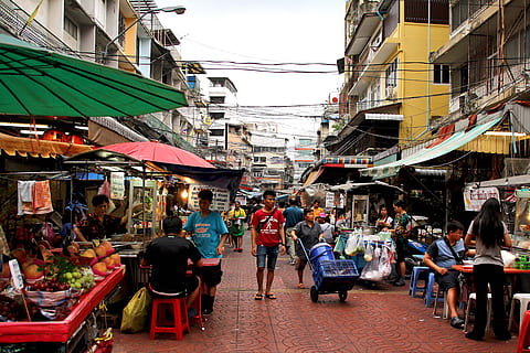 mass of people walking on isle surrounded by stores and stands beside buildings HD wallpaper