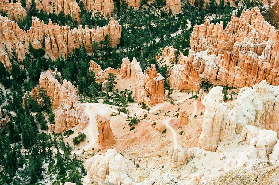 postal aerial photography of brown rock formations at daytime, aerial view of mountain surrounded by trees HD wallpaper