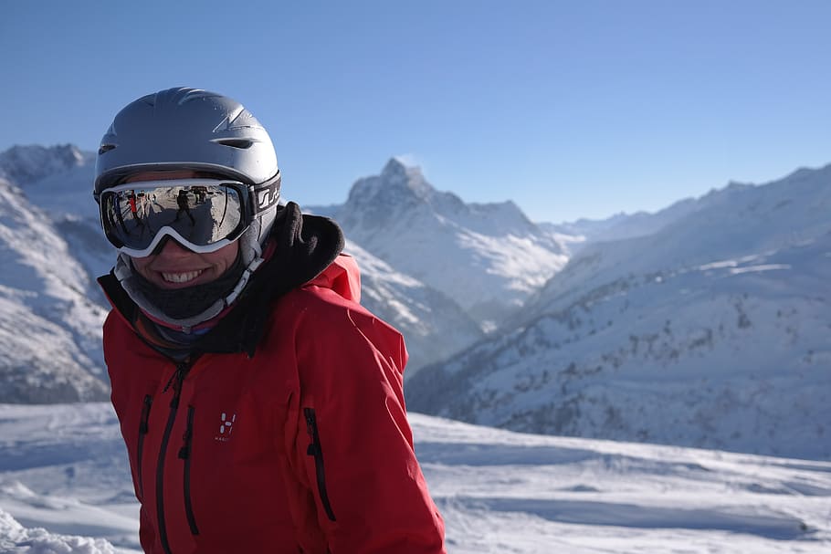 man wearing jacket standing on snowfield wearing helmet and goggles HD wallpaper