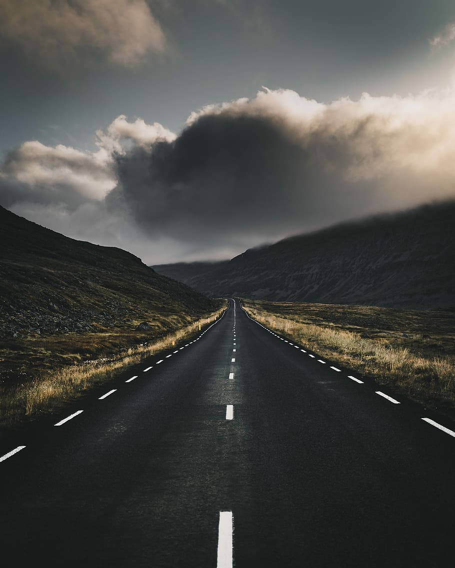 concrete road near mountain, black pathway during cloudy day HD wallpaper