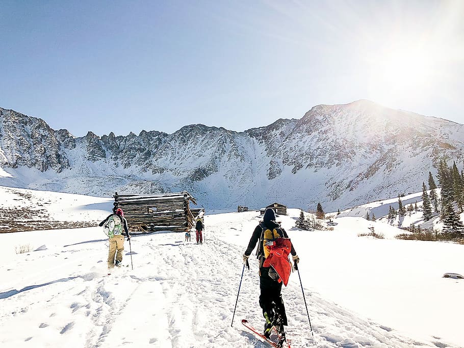 man riding on skis, person holding snow skis and stick, mountain HD wallpaper