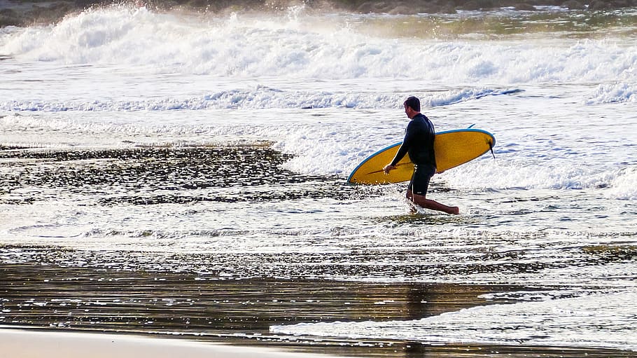 person holding yellow surfboard while walking on seashore, Beach, Sand HD wallpaper