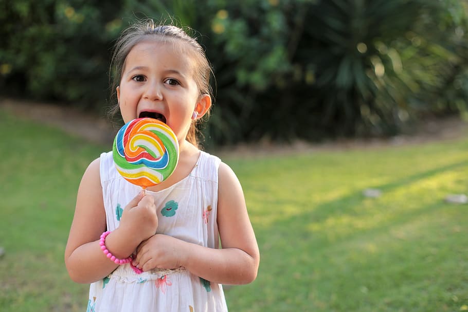 Eden turns 5…with a lolipop, toddler's licking multicolored lollipop