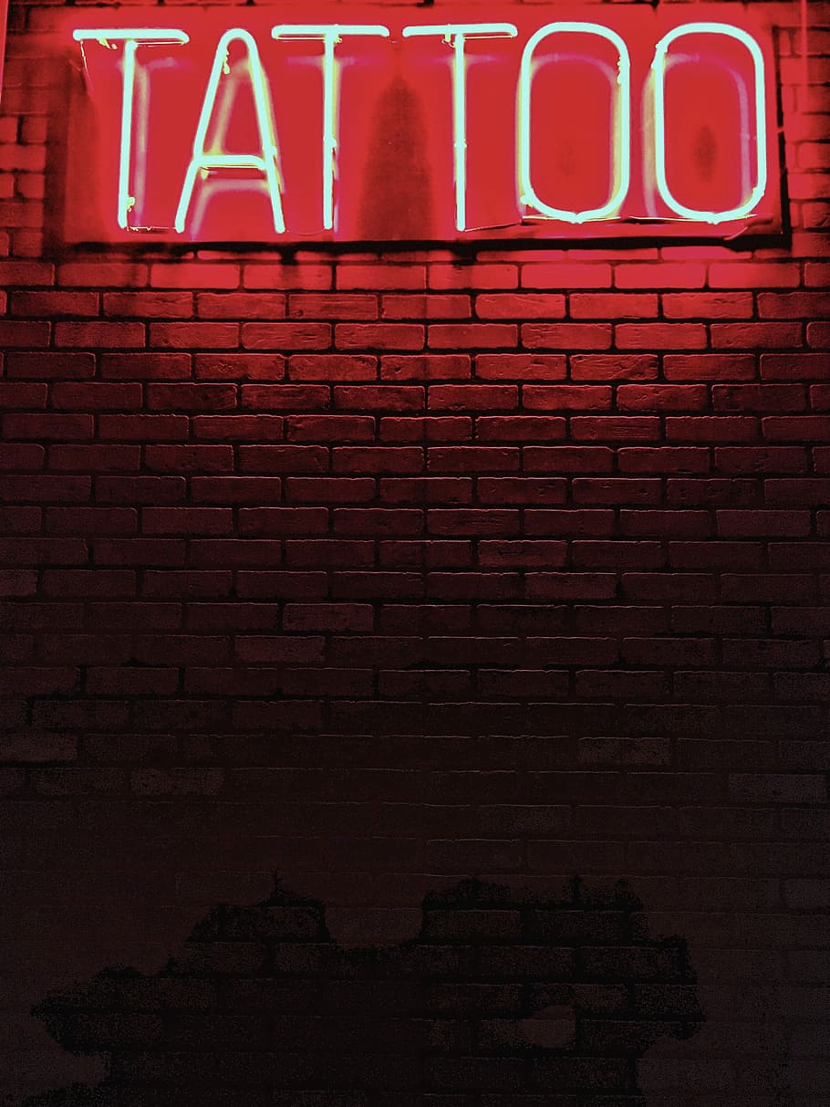 red Tattoo neon light signage, lighted tattoo signage on brick wall