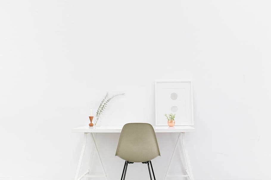 gray chair in front of white table, rectangular, wooden, placed