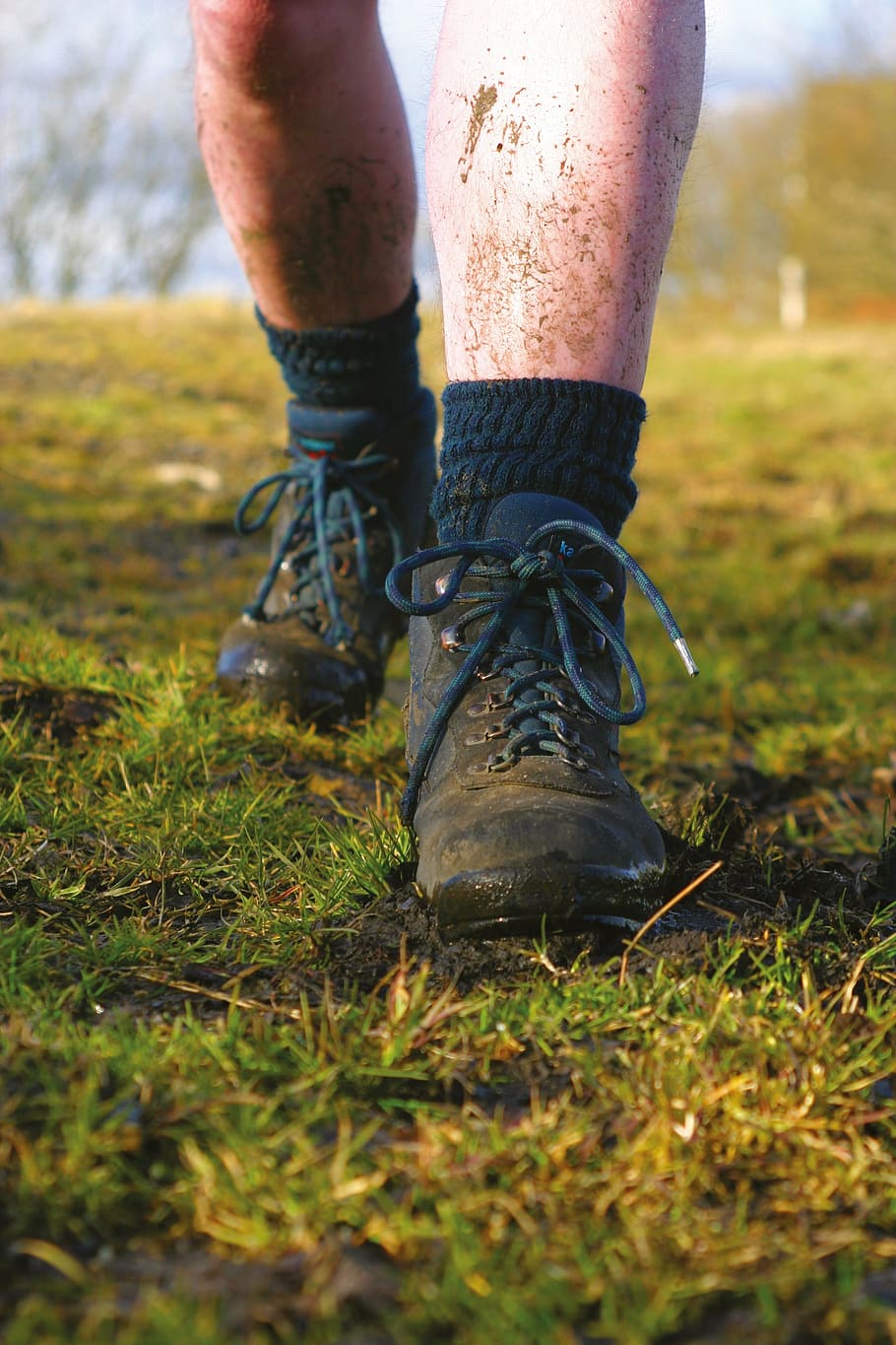 man wearing black leather boots standing on mud at daytime HD wallpaper