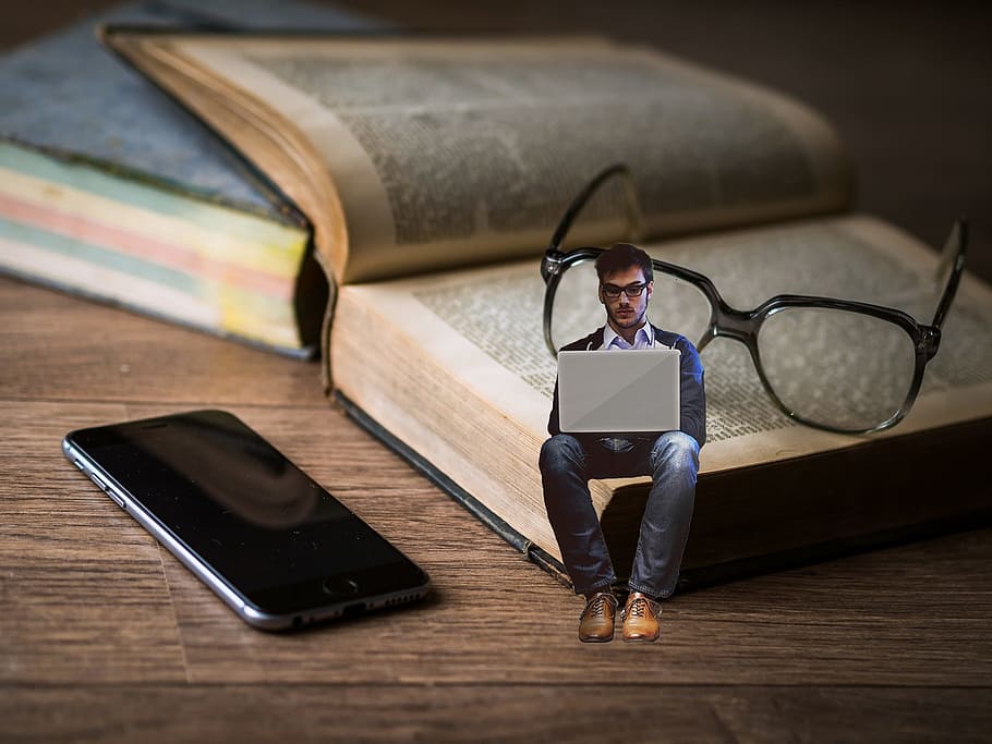 man with laptop edited photo sitting on book with eyeglasses near black iPhone 7, HD wallpaper