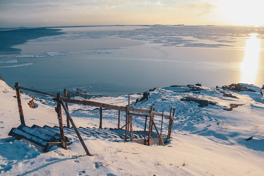 brown stairs on snow-covered mountain near body of water during daytime, brown wooden dock near body of water covered by snow HD wallpaper