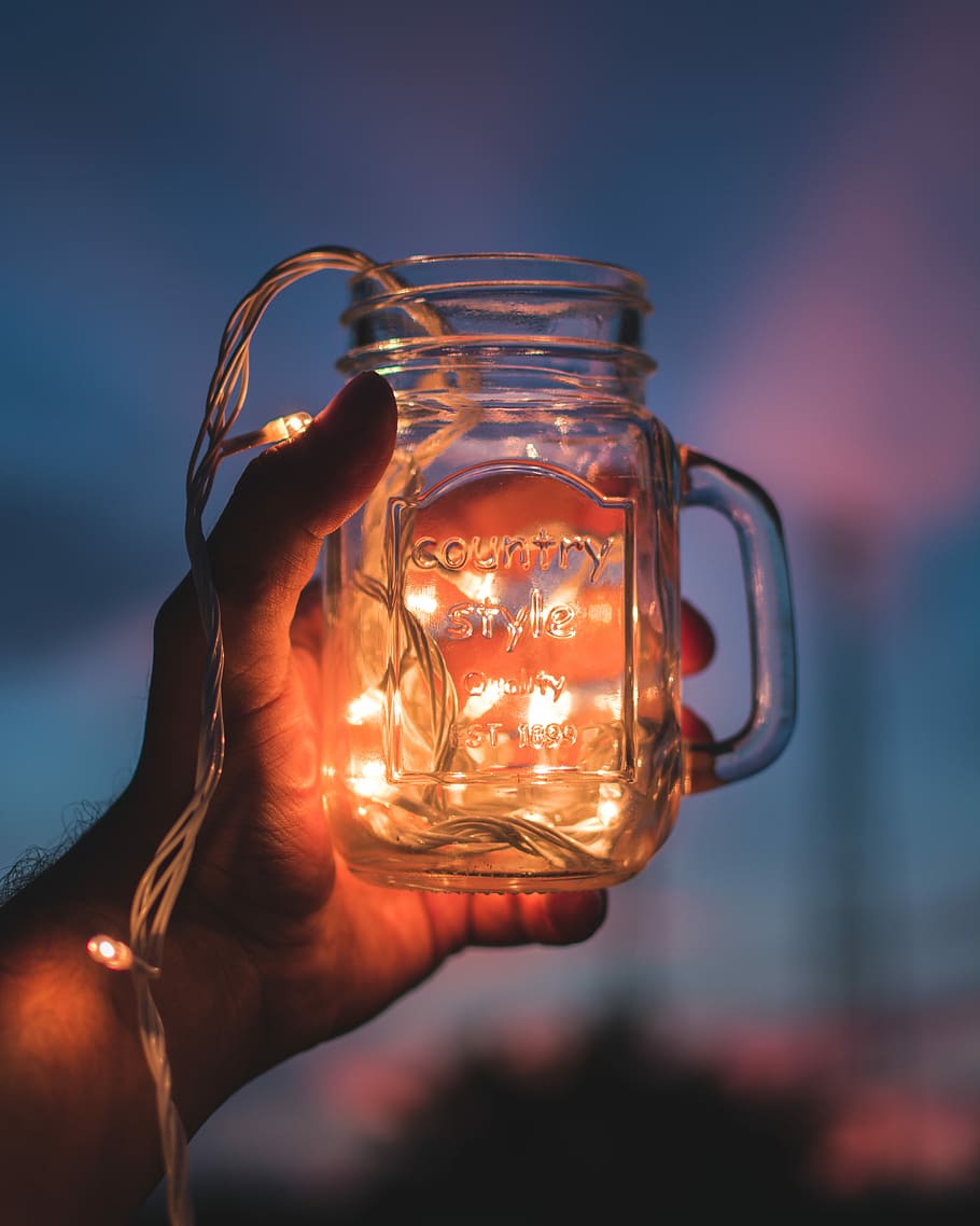person holding jar with lighted string lights, person holding clear mason jar HD wallpaper