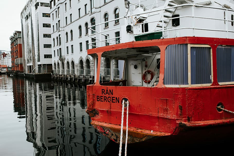 red boat near white building, red and white boat on body of water beside white high-rise building HD wallpaper