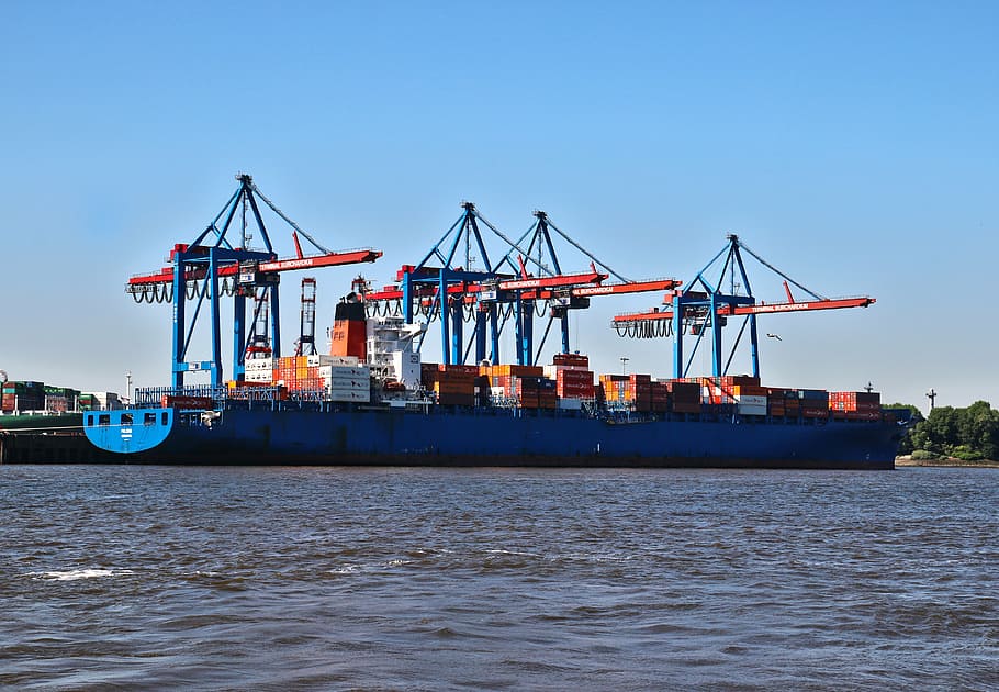crane inside the cargo ship on body of water during daytime HD wallpaper
