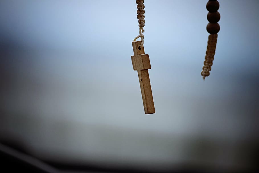 shallow focus photography of brown wooden cross accessory, religious