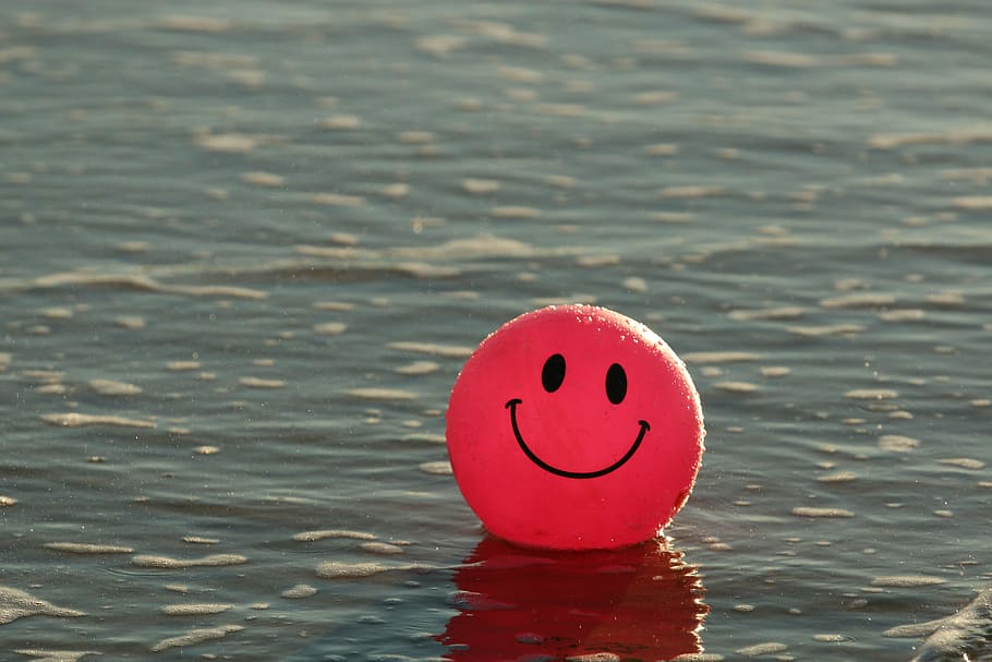 red emoji balloon in sea at daytime, beach, happy, ocean, pink, HD wallpaper