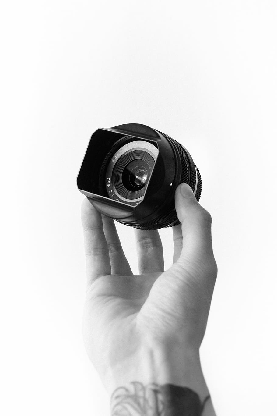 grayscale photo of person holding camera lens, selective color photography of person holding camera zoom lens HD wallpaper