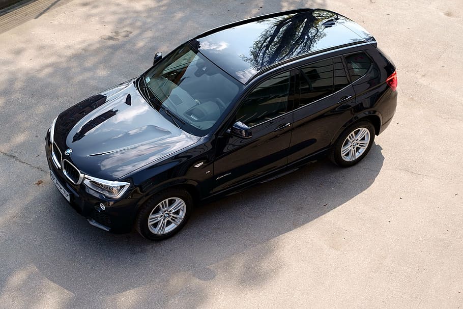 black BMW X1 SUV parked on concrete pavement, car, x3, vehicle
