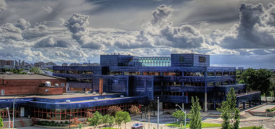 blue and brown concrete building under cloudy sky during daytime HD wallpaper