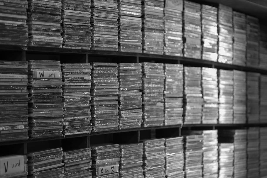 assorted DVD case lot, grayscale photography of CD case lot, cds
