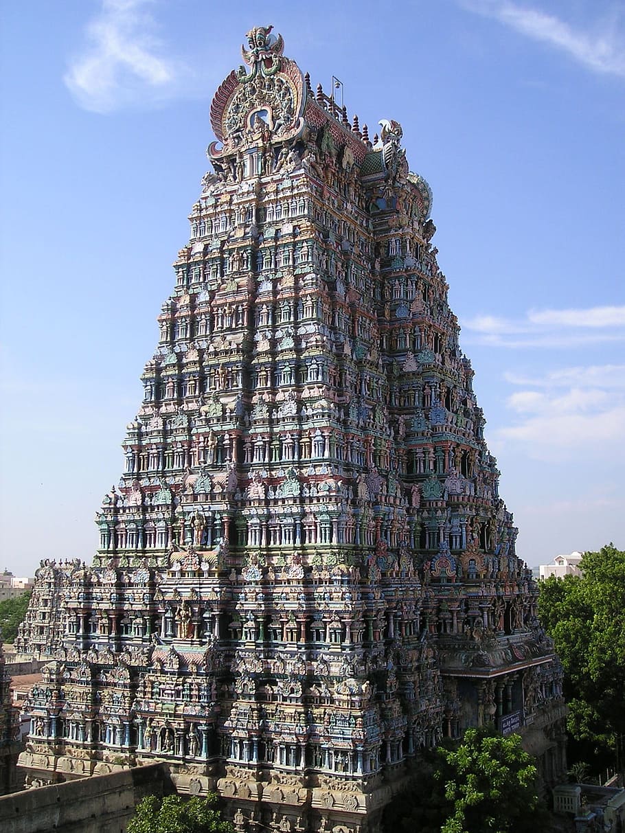 gray and red monolith surrounded with trees, india, temple, tower
