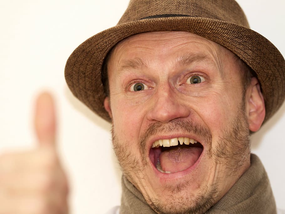 close-up photo of man open his mouth while doing thumbs up, hat, HD wallpaper