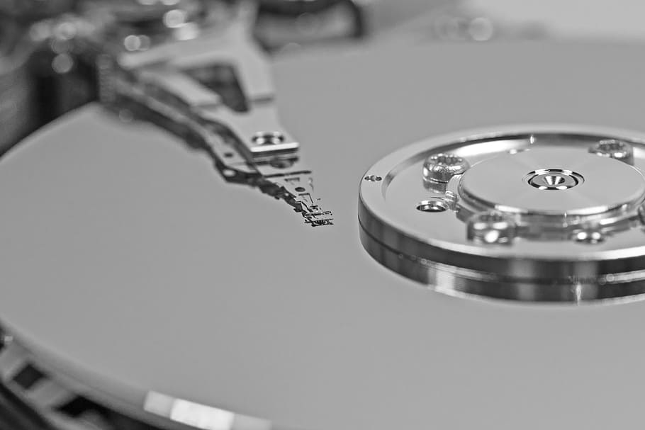 close-up photography of hard drive disc, detail, read head, inner workings