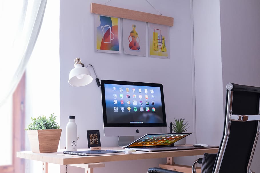 white iMac on brown wooden desk, turned on silver iMac on desk HD wallpaper
