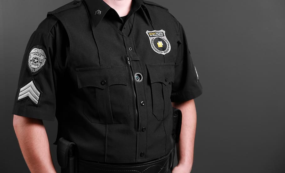 man wearing black uniform, bodyworn, body camera, police body camera