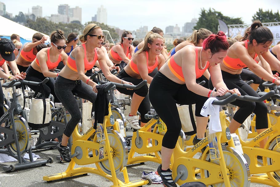 time lapse photography of women riding stationary bikes, team HD wallpaper