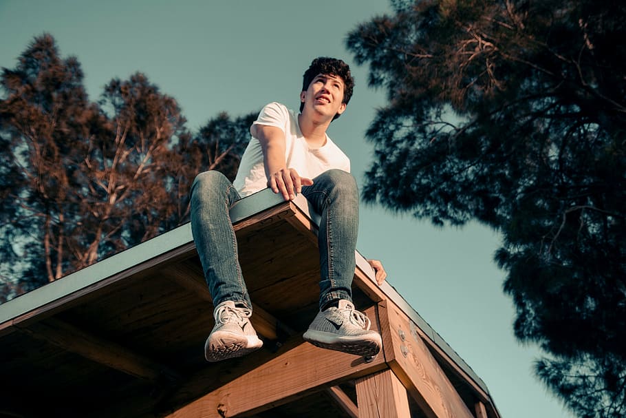 low angle photo of man sitting on the roof of the house, people HD wallpaper