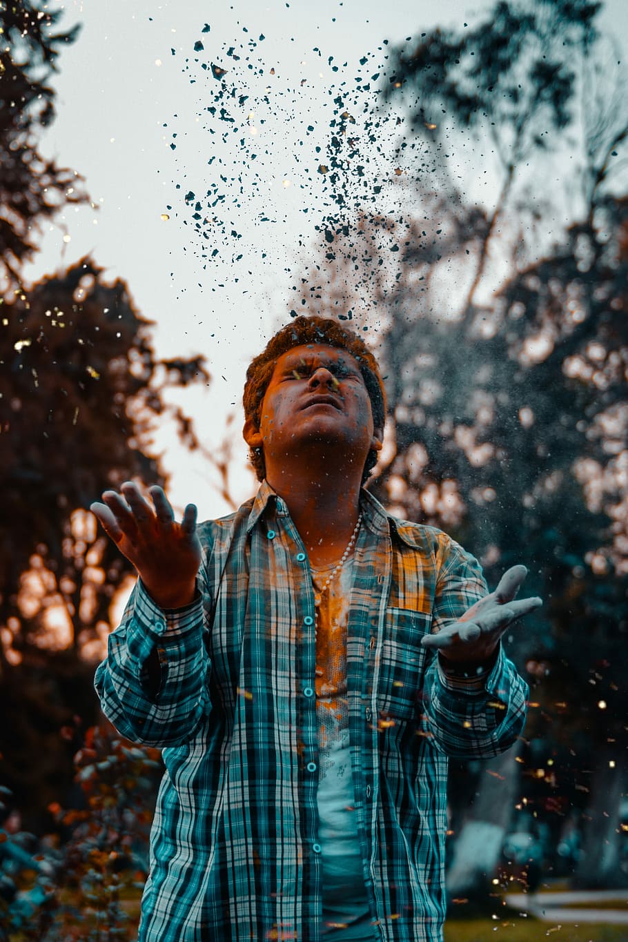 man looking up while raising his both hands, person playing with teal tint during daytime HD wallpaper