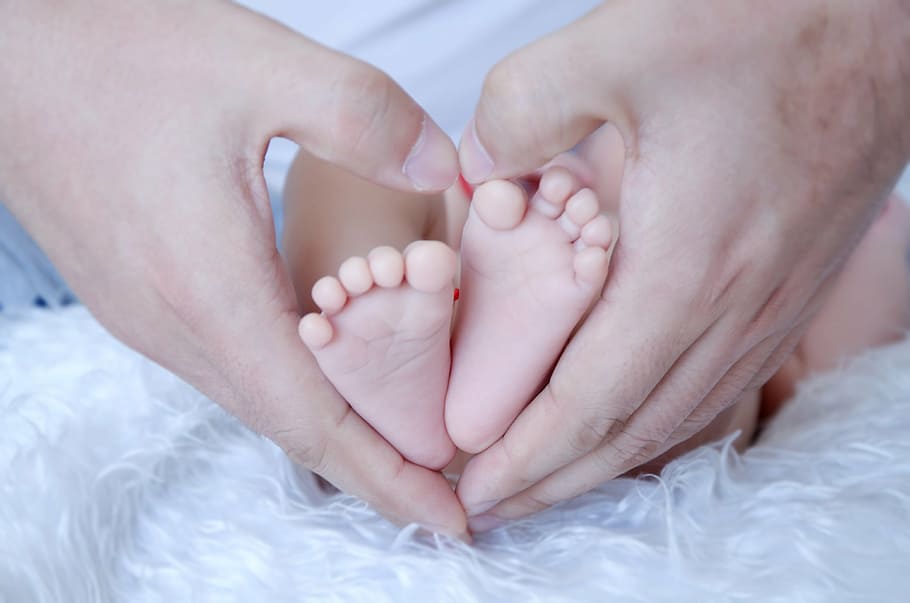 person making hand heart with baby's feet, father, family, child