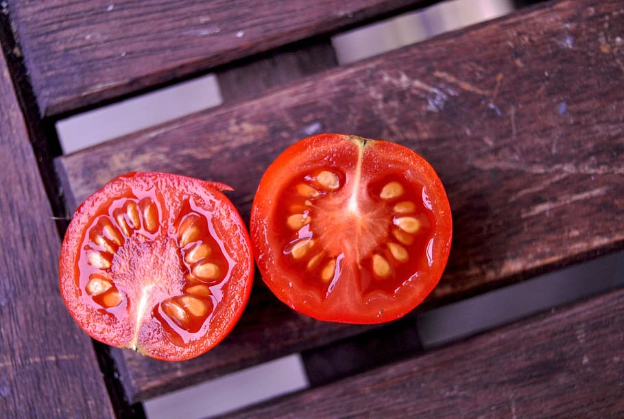 two slice tomato on brown wooden surface, vegetables, tomatoes