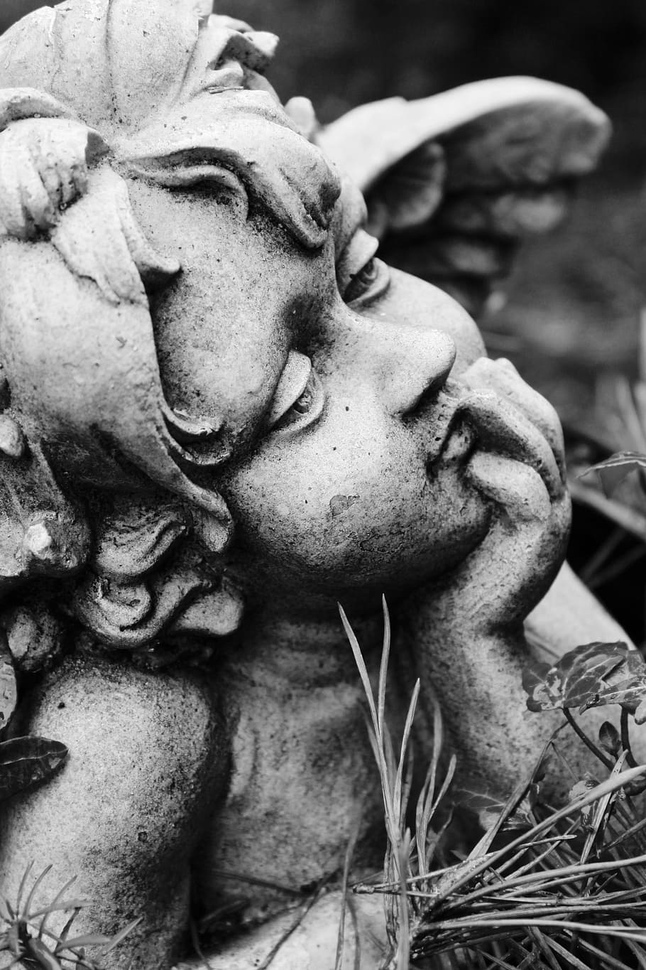closeup photo of concrete cherub statuette, angel, commemorate