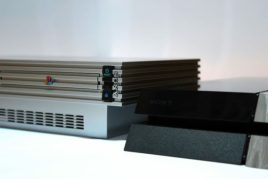 Sony PS2 beside PS4 consoles, gray Sony PS2 fat console placed on white surface, HD wallpaper