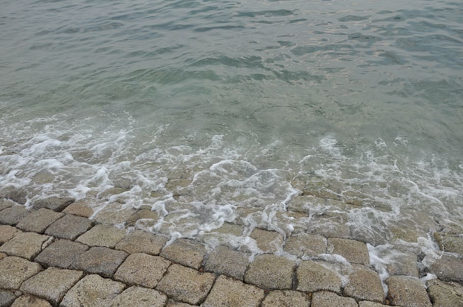 qingdao, sea, wave, stone, foam, water, motion, aquatic sport HD wallpaper