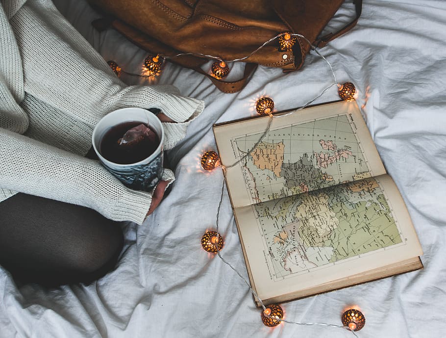 Almanac book on white textile, map, atlas, lights, string lights HD wallpaper