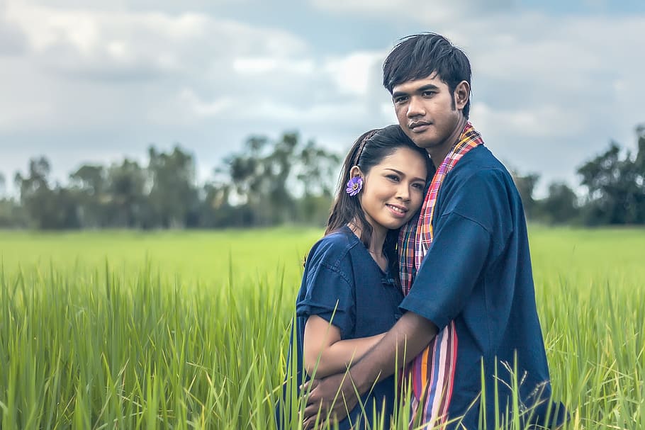 man and woman hugging on green grass field, pair, family, asia